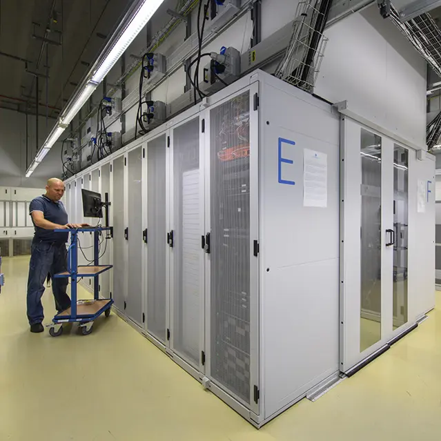 Interior of data center with server racks and worker