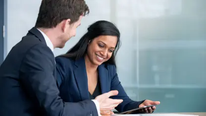 Businessman and businesswoman reviewing documents together