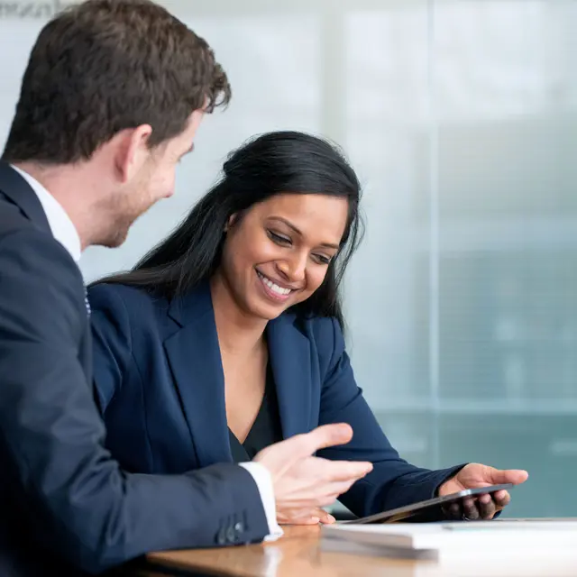 Businessman and businesswoman reviewing documents together