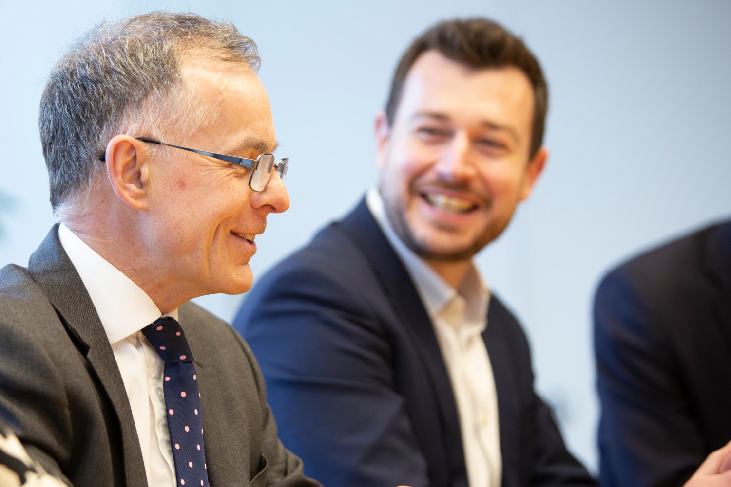 Two smiling businessmen in conversation